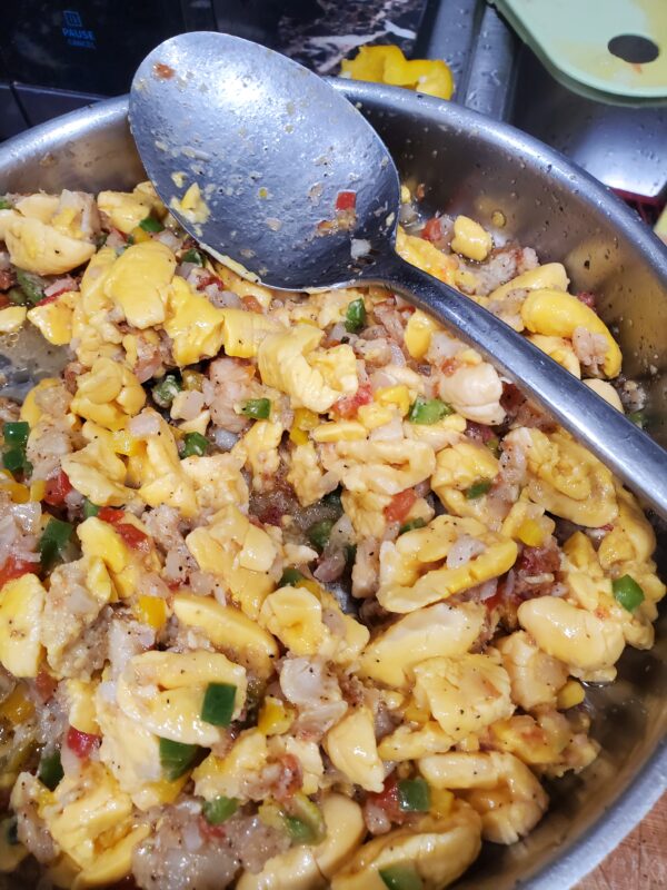 A bowl of food with corn and other ingredients.